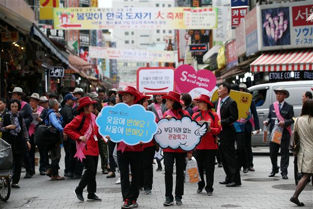  20일 오전 서울 남대문시장에서 상인과 관광업계 관계자들이 서울 주요 관광특구에서 부당 요금과 호객행위를 근절하고, 친절과 환대를 다짐하는 뜻을 담은 ‘자정결의 캠페인’을 벌이고 있다.  연합뉴스