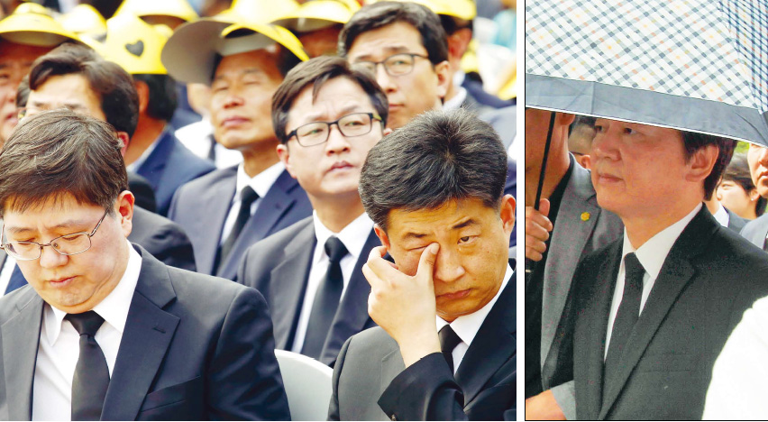 노무현 전 대통령 서거 7주기 추도식이 열린 23일 오후 경남 김해시 진영읍 봉하마을에서 노 전 대통령의 장남 노건호(왼쪽 사진 오른쪽)씨가 눈물을 닦고 있다. 노씨 옆은 김홍걸 더불어민주당 국민통합위원장. 안철수 국민의당 공동대표(오른쪽 사진)는 경찰의 우산 경호를 받으며 묘역에 들어섰다. 김해/공동취재사진