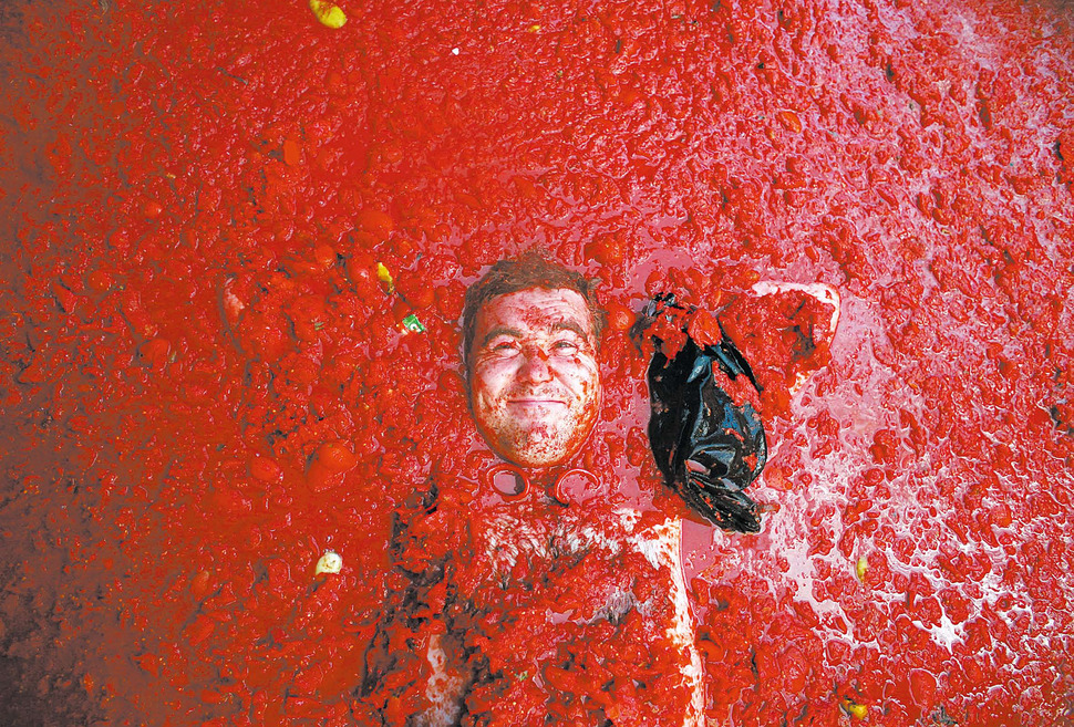 스페인 발렌시아 인근의 지중해 마을 부놀에서 열린 연례 토마토 전쟁 “토마티나(Tomatina)”에서 한 열성 참가자가 토마토 과육
에 파묻혀 있다. 마르셀로 델 포소 / 부놀, 스페인(2006. 8. 30)