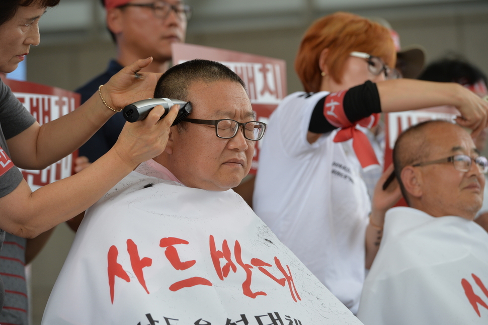 이필용 음성군수(왼쪽)가 11일 음성 설성공원에서 열린 사드 반대 결의대회에서 삭발하고 있다. 음성군 제공