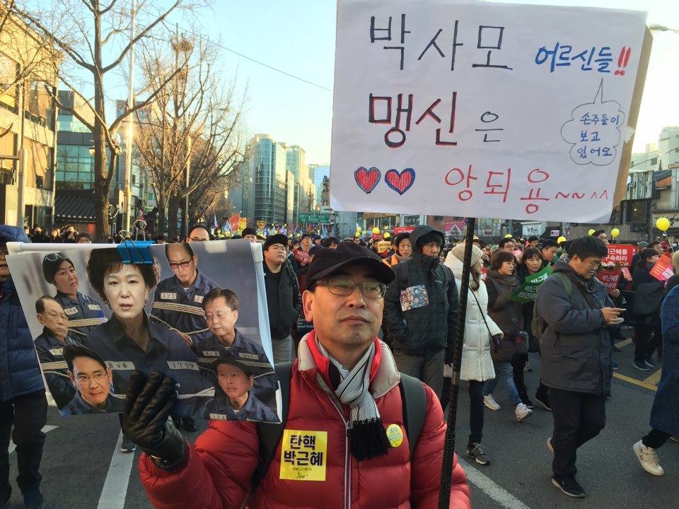 10일 오후 4시 서울 광화문광장 일대에서 열린 7차 촛불집회에서 한 시민이 “박사모 어르신들 맹신은 안 돼용”이라고 쓰여진 손팻말을 들고 행진하고 있다. 사진 김규남 기자.