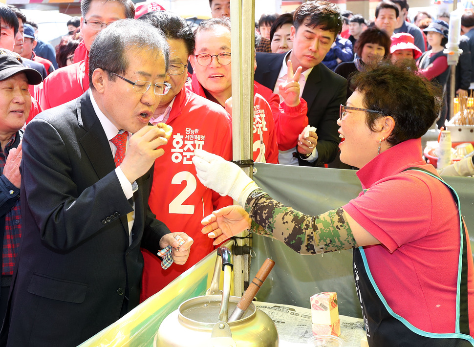 자유한국당 홍준표 대선후보가 18일 오전 울산 남창시장에서 상인이 준 국화빵을 먹고 있다. 연합뉴스