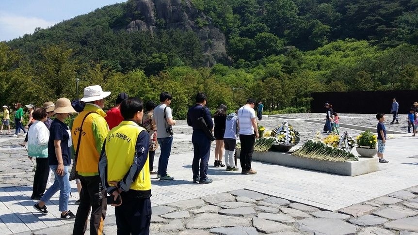 21일 경남 김해시 진영읍 봉하마을의 노무현 대통령 묘역에 참배객들이 헌화하고 있다.