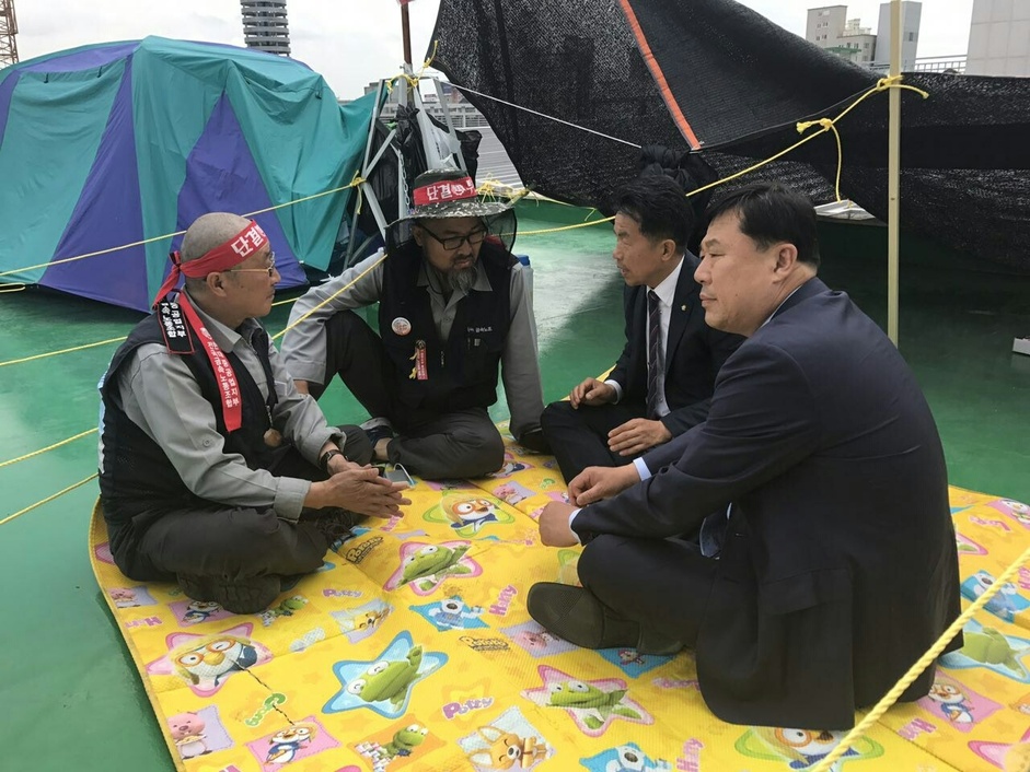 김종훈·윤종오 국회의원(오른쪽부터)이 울산시의회 의사당 옥상 농성장을 찾아 농성 중인 금속노조 현대중공업지부 김진석 수석부지부장과 김병조 정책기획실장(왼쪽부터)의 이야기를 듣고 있다. 민주노총 울산본부 제공