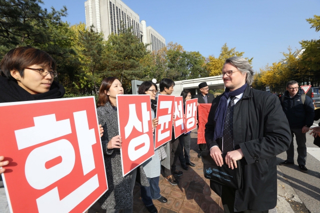 한상균 민주노총 위원장의 항소심 선고가 있던 지난해 12월8일 오후 서울 서초구 서초동 법조타운 앞에서 얀 에릭 웨첼 국제앰네스티 동아시아 정책고문이 한 위원장 석방을 촉구하는 민주노총 관계자들을 바라보고 있다. 김봉규 선임기자 bong9@hani.co.kr