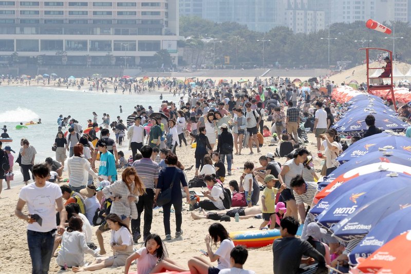 4일 부산 해운대해수욕장에서 피서객들이 물놀이하며 더위를 식히고 있다. 공식개장보다 한 달 일찍 문을 연 해운대해수욕장에는 징검다리 연휴를 맞아 많은 피서객이 몰렸다. 부산/연합뉴스