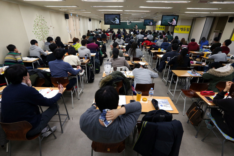 2015년 1월 서울 동작구 대방동의 한 9급공무원 취업준비학원에서 한 취업준비생이 수업 중 손수건으로 목의 땀을 닦고 있고 그 앞의 취업준비생은 책상에 엎드려 있다. 이정아 기자 leej@hani.co.kr