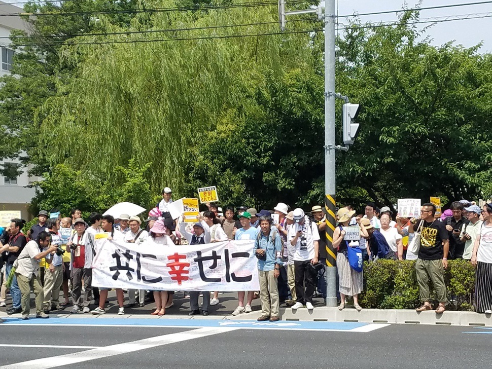 16일 일본 가나가와현 가와사키시 평화공원에서 시민들이 ‘같이 행복하게’라고 쓰인 펼침막을 들고 헤이트 스피치 반대 시위를 하고 있다.
