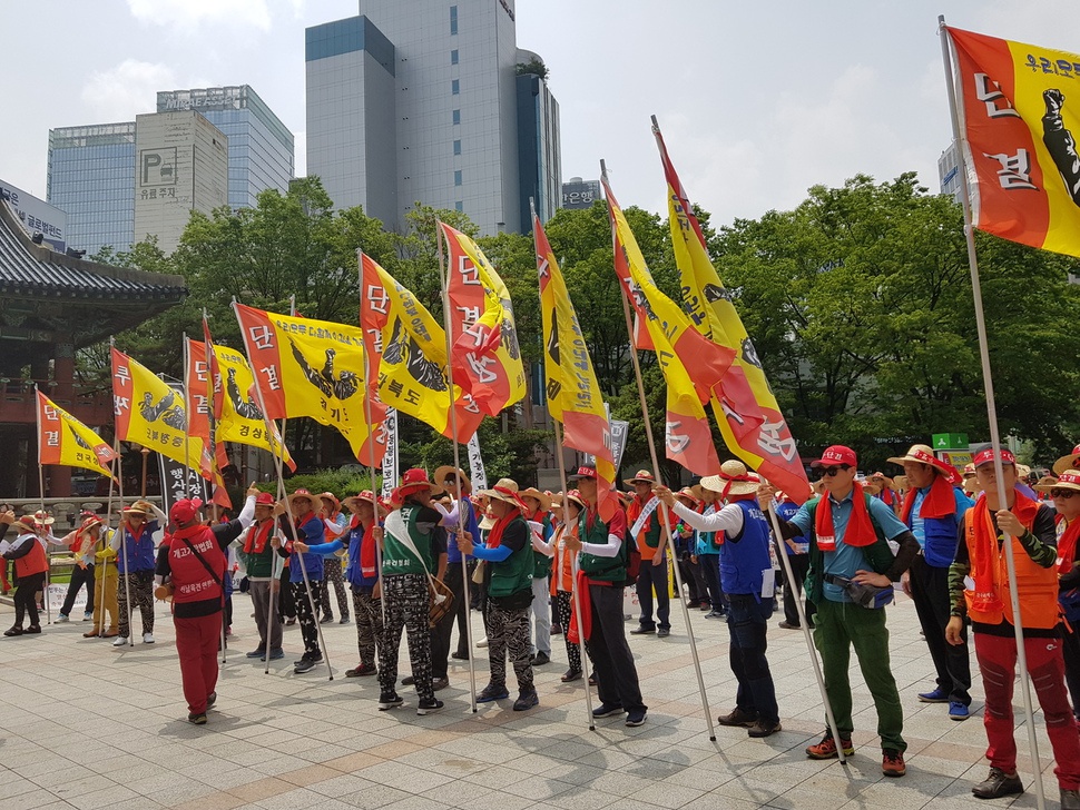 6일 낮 서울 종로 보신각 앞에서 집회를 시작하기 위해 모인 육견협회 회원들이 지역별 깃발을 들고 있다.