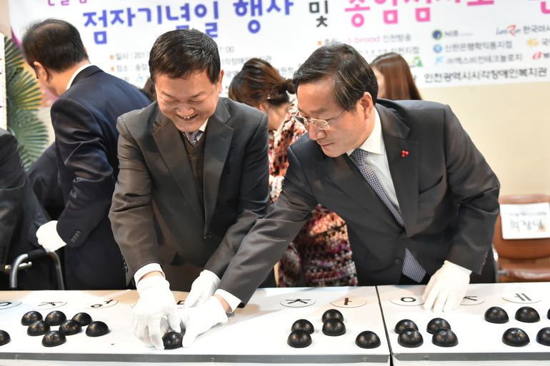 유정복 인천시장이 29일 송암점자도서관에서 가진 ‘송암점자도서관 개관식’에서 훈맹정음을 점자로 붙이는 퍼포먼스를 하고 있다. 사진 인천시 제공