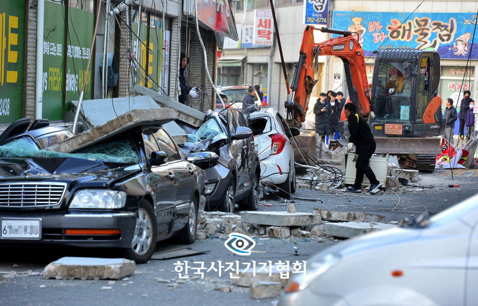 <스팟뉴스 부문> 11월15일 경북 포항에서 규모 5.4 강진이 발생한 가운데 진앙지와 인접한 포항시 흥해읍 마산리에서 한 마트의 옥상 담벽이 무너지면서 주차된 차량을 덮쳐 일대가 아수라장으로 변해있다. <경상일보> 김동수 기자/한국사진기자협회 제공