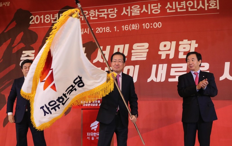 자유한국당 홍준표 대표가 16일 오전 서울 마포구 케이터틀에서 열린 서울시당 신년인사회에서 당기를 흔들고 있다. 왼쪽부터 김선동 서울시당 위원장, 홍 대표, 김성태 원내대표. 강창광 기자 chang@hani.co.kr