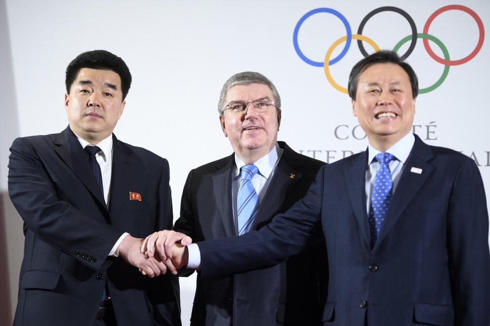 토마스 바흐 국제올림픽위원회(IOC) 위원장이 20일 스위스 로잔의 아이오시 본부에서 도종환(오른쪽) 문화체육관광부 장관과 북한의 김일국 체육상과 함께 악수하고 있다. 로잔/AP 연합뉴스