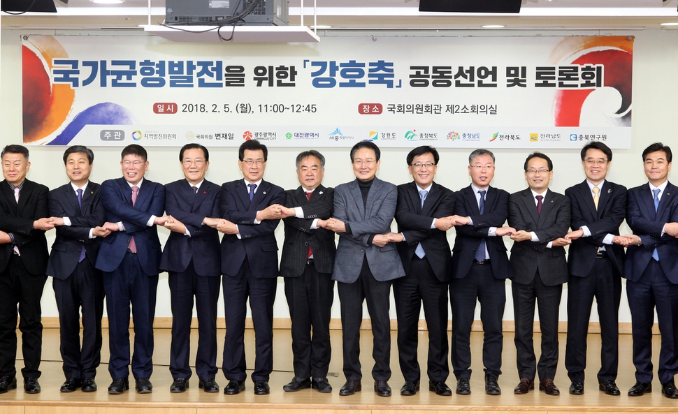 이시종 충북지사(왼쪽 다섯째), 송재호 지역발전위원장(왼쪽 여섯째), 박준영(왼쪽 넷째)·변재일(왼쪽 일곱째) 국회의원 등 강원·충청·호남 자치단체장과 국회의원 등이  5일 국회에서 손을 맞잡고 국가 균형발전을 위한 ‘강호축’ 의제 국가 정책 반영을 건의했다.충북도 제공