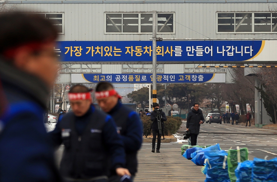 한국지엠이 전북 군산공장 폐쇄를 결정했다는 소식이 알려진 지난달 14일 민주노총 금속노조 전북지부 조합원들이 머리띠를 두르고 공장 동문으로 출근하고 있다. 연합뉴스