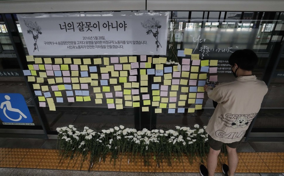 구의역 스크린 도어 사고 2주기를 하루 앞둔 27일 오후 서울 광진구 구의역 강변역 방면 9-4 승강장에서 한 시민이 희생자 김군을 추모하는 쪽지를 붙이고 있다. 박종식 기자 anaki@hani.co.kr