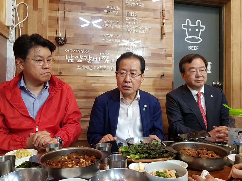 자유한국당 홍준표 대표(가운데)가 11일 오후 대구 서문시장을 깜짝 방문해 장제원(왼쪽), 강효상 의원과 식사하고 있다. 사진 연합뉴스.