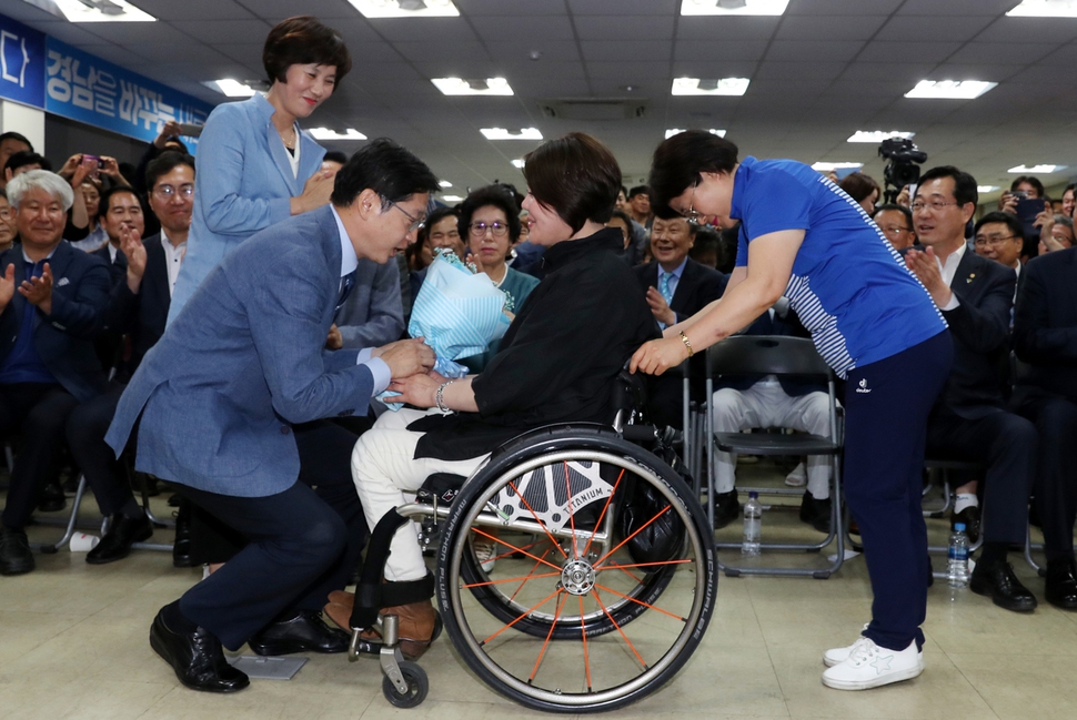 김경수 더불어민주당 경남도지사 후보가 14일 새벽 창원시 신월동 선거대책위 사무실에서 개표 결과 당선이 확정되자, 김영순 장애인선대본 공동본부장(신장유장애인자립생활지원센터장)으로부터 무릎을 굽힌 채 꽃다발을 받고 있다.  창원/강재훈 선임기자 khan@hani.co.kr