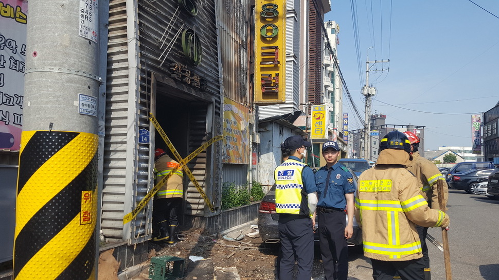 18일 경찰과 소방대원들이 군산 화재 현장을 조사하고 있다. 이정하 기자