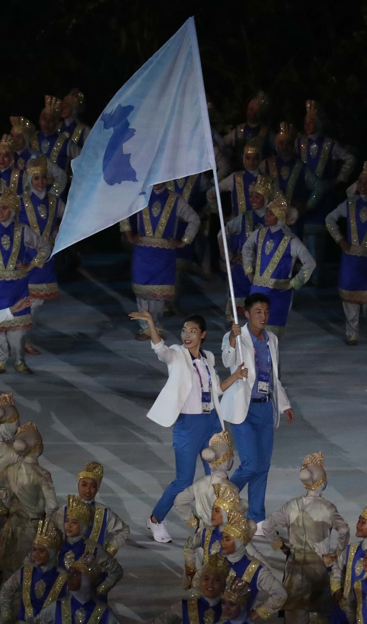 남쪽 농구선수 임영희와 북쪽 축구선수 주경철이 든 푸른 한반도기를 든 채 입장하고 있다. 자카르타/백소아 기자