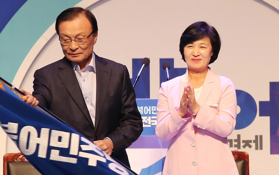 추미애 전 더불어민주당 대표(오른쪽)가 25일 오후 서울 올림픽 체조경기장에서 열린 전국대의원대회에서 이해찬 신임 대표에게 당기를 넘긴 뒤 박수치고 있다. 신소영 기자 viator@hani.co.kr