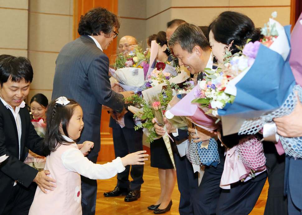 19일 오전 서울 종로구 재동 헌법재판소 청사 1층에서 열린 헌법재판관 퇴임식에서 이진성 헌법재판소장 등 퇴임하는 재판관들이 가족들로부터 꽃다발을 받고 있다. 헌법재판소 제공