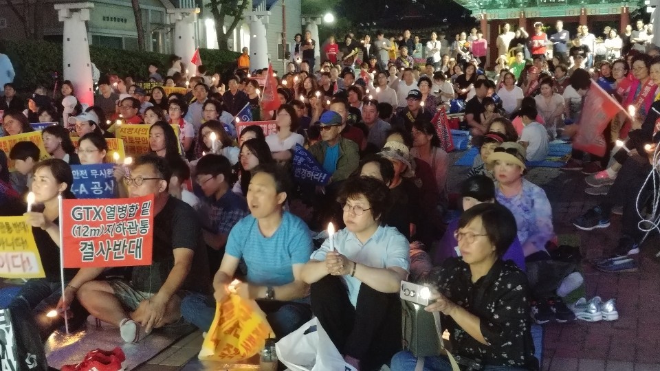 경기도 파주시 교하 주민 600여명이 지난 21일 교하 중앙공원에서 지티엑스-에이 노선 변경을 촉구하며 토요 촛불집회를 열고 있다.