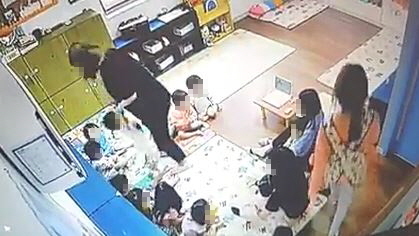 청주의 한 어린이집 원아가 보육교사에게 학대당했다는 신고가 접수돼 경찰이 수사에 나섰다. 사진은 보육교사가 아이의 양손을 잡고 들어 올리는 장면. 사회관계망서비스 갈무리