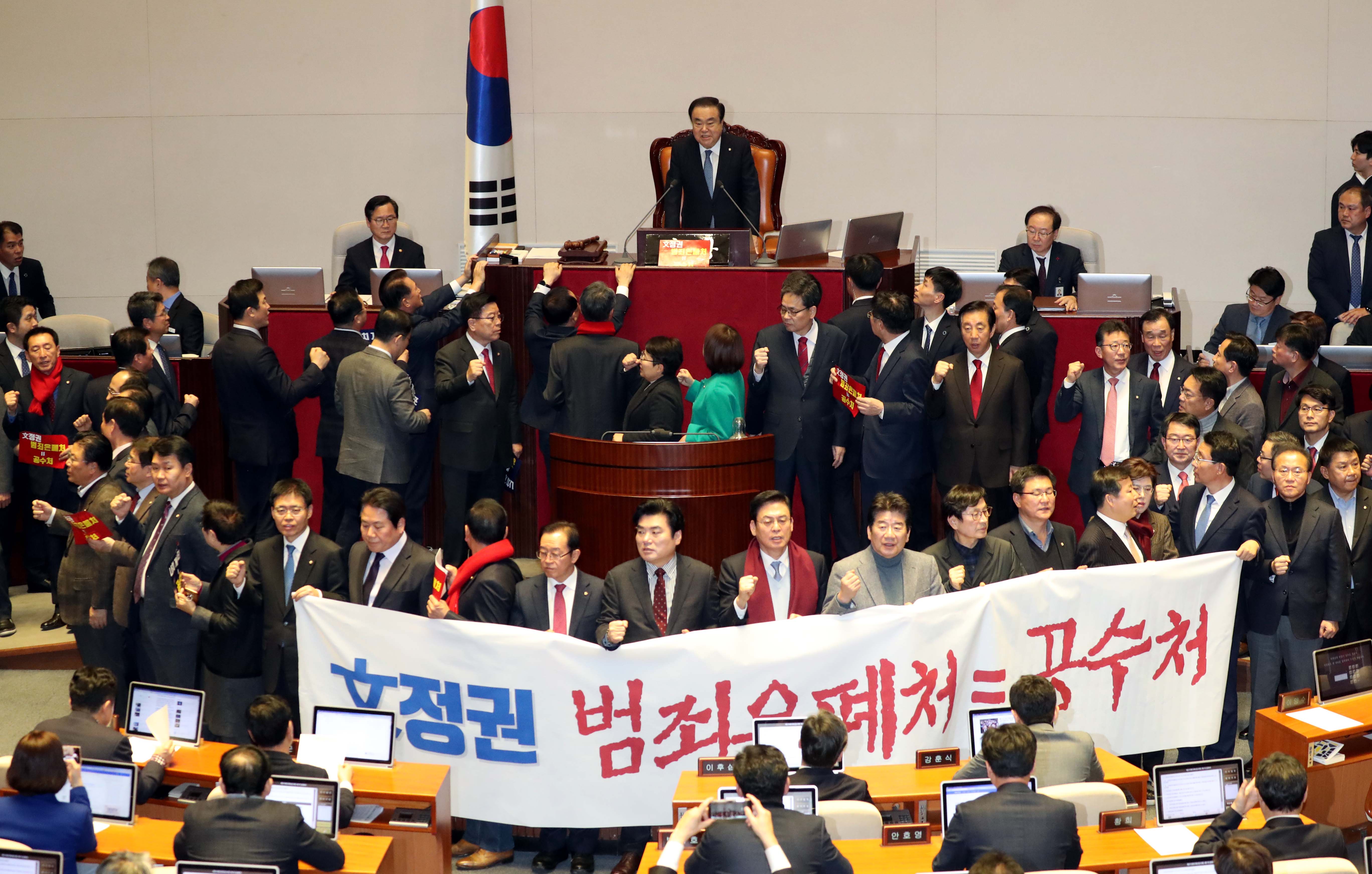 공수처 반대시위하는 한국당
'고위공직자범죄수사처 설치 법안' 본회의 표결을 앞두고 30일 저녁 국회 본회의에서 문희상 국회의장이 개의를 선언하자 자유한국당 의원들이 펼침막을 들고 공수처반대 시위를 벌이고 있다. 강창광 선임기자 chang@hani.co.kr