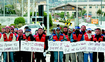 Against pay cuts and longer hours